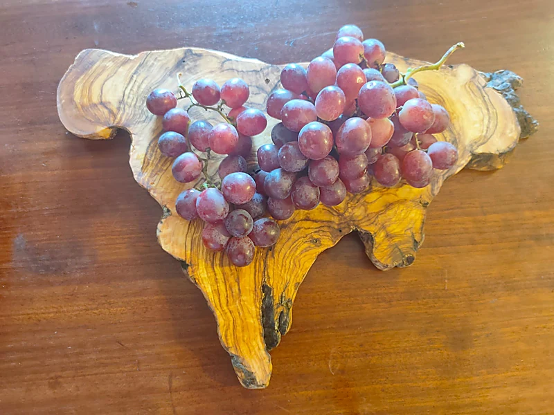 Grapes on olive-wood board